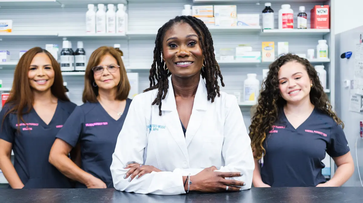 Dr. Eugenia Osei-Wusu and the Alamo Ranch Pharmacy & Wellness team at the pharmacy counter